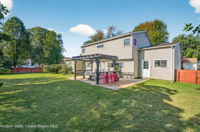 a view of a house with backyard and porch