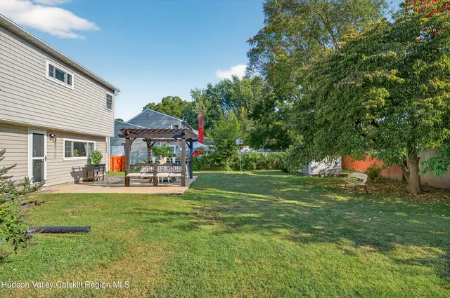 a view of a house with a yard and sitting area