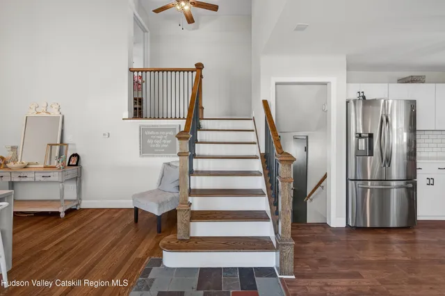 a view of entryway and hall with wooden floor