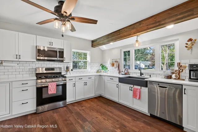 a kitchen with stainless steel appliances granite countertop a stove and a sink
