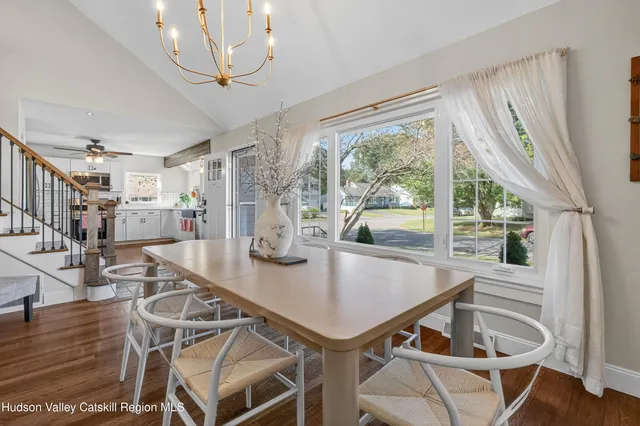 a view of a dining room with furniture large windows and wooden floor