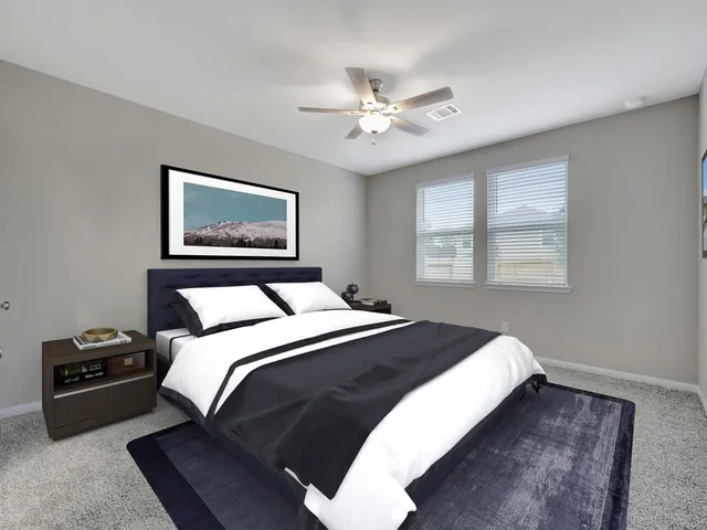 a bedroom with a large bed and a window