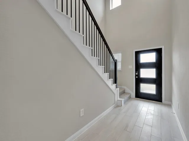 a view of staircase with white walls and stairs