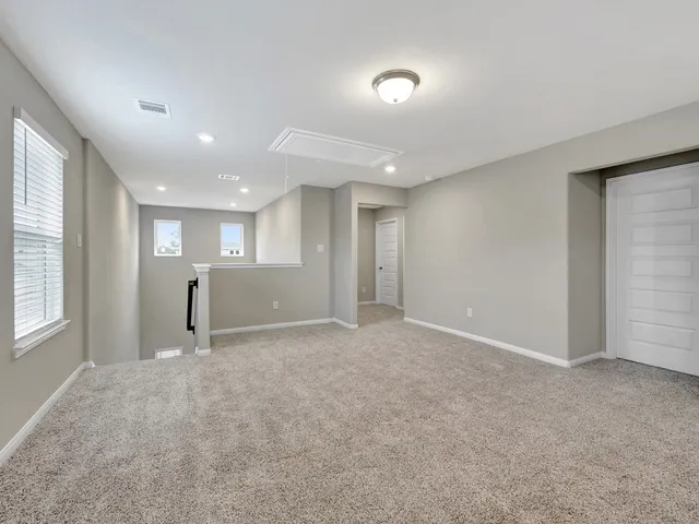 a view of an empty room and a window