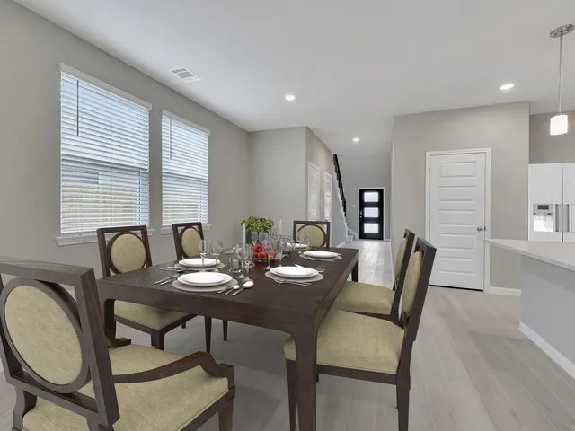 a view of a dining room with furniture and window