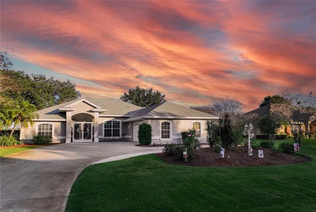 a front view of a house with a yard table and chairs