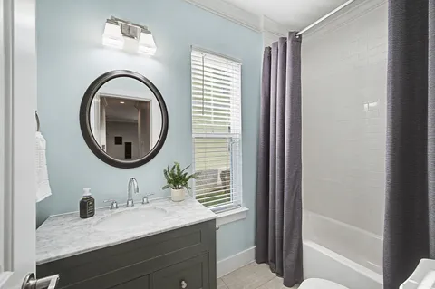 a bathroom with a sink a mirror and a shower
