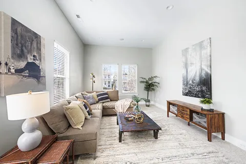 a living room with furniture rug and window