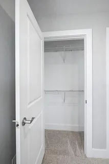 a bathroom with a granite countertop double vanity sink and mirror
