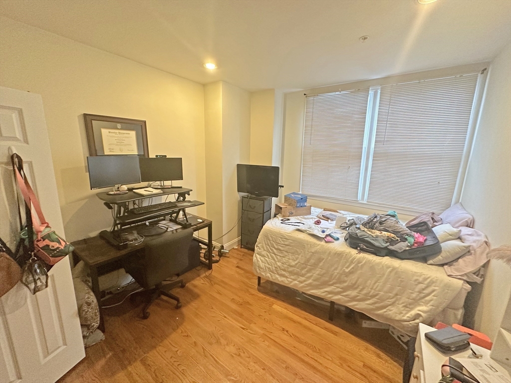 550 East 3rd Street Boston, MA 02127 - Photo 10 of 12 a bedroom with a bed and a computer on a desk