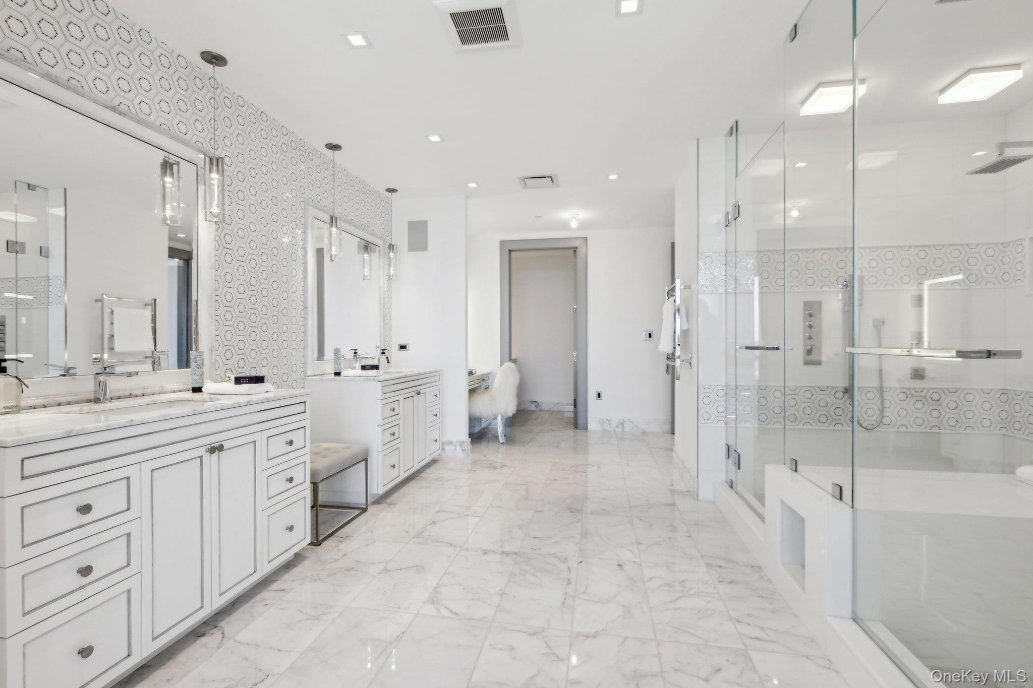5 Renaissance Square, Unit PH41 ENT White Plains, NY 10601 - Photo 12 of 39 a large bathroom with a double vanity sink a large mirror and shower