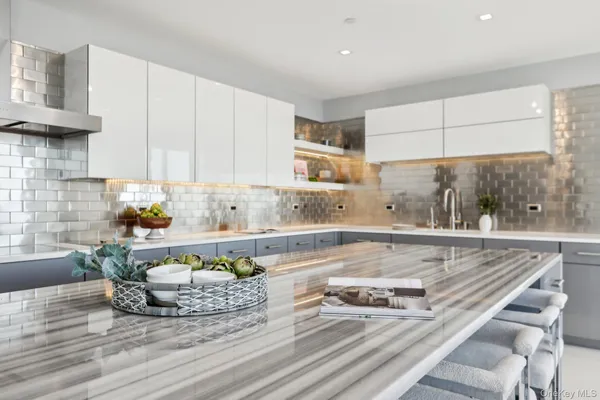 a view of a kitchen with granite countertop white cabinets and stainless steel appliances