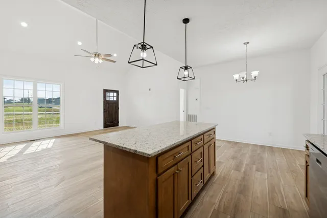 a view of a room with wooden floor closet and a ceiling fan