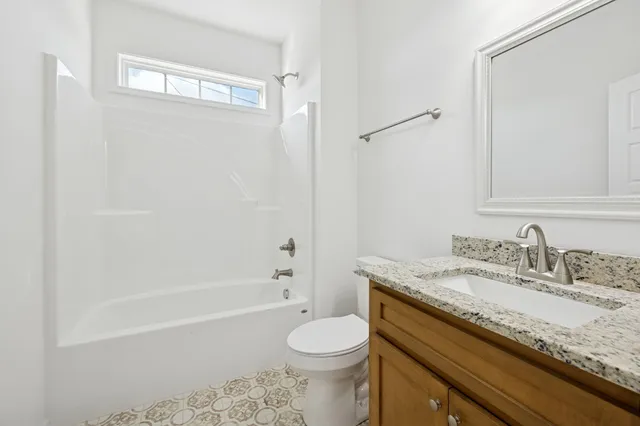 a bathroom with a granite countertop sink a mirror and a