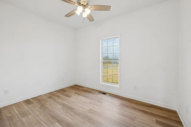 a view of a room with wooden floor and small space