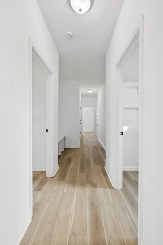 an empty room with a ceiling fan and window