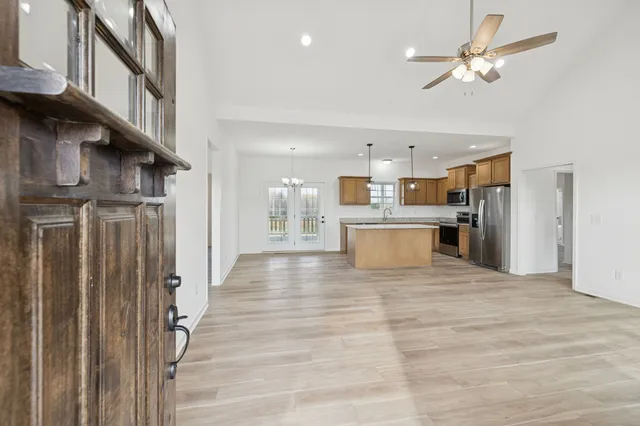 a large kitchen with stainless steel appliances granite countertop a lot of counter space