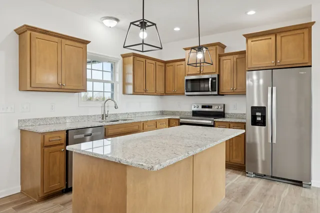 a view of an empty room with a fireplace and a window