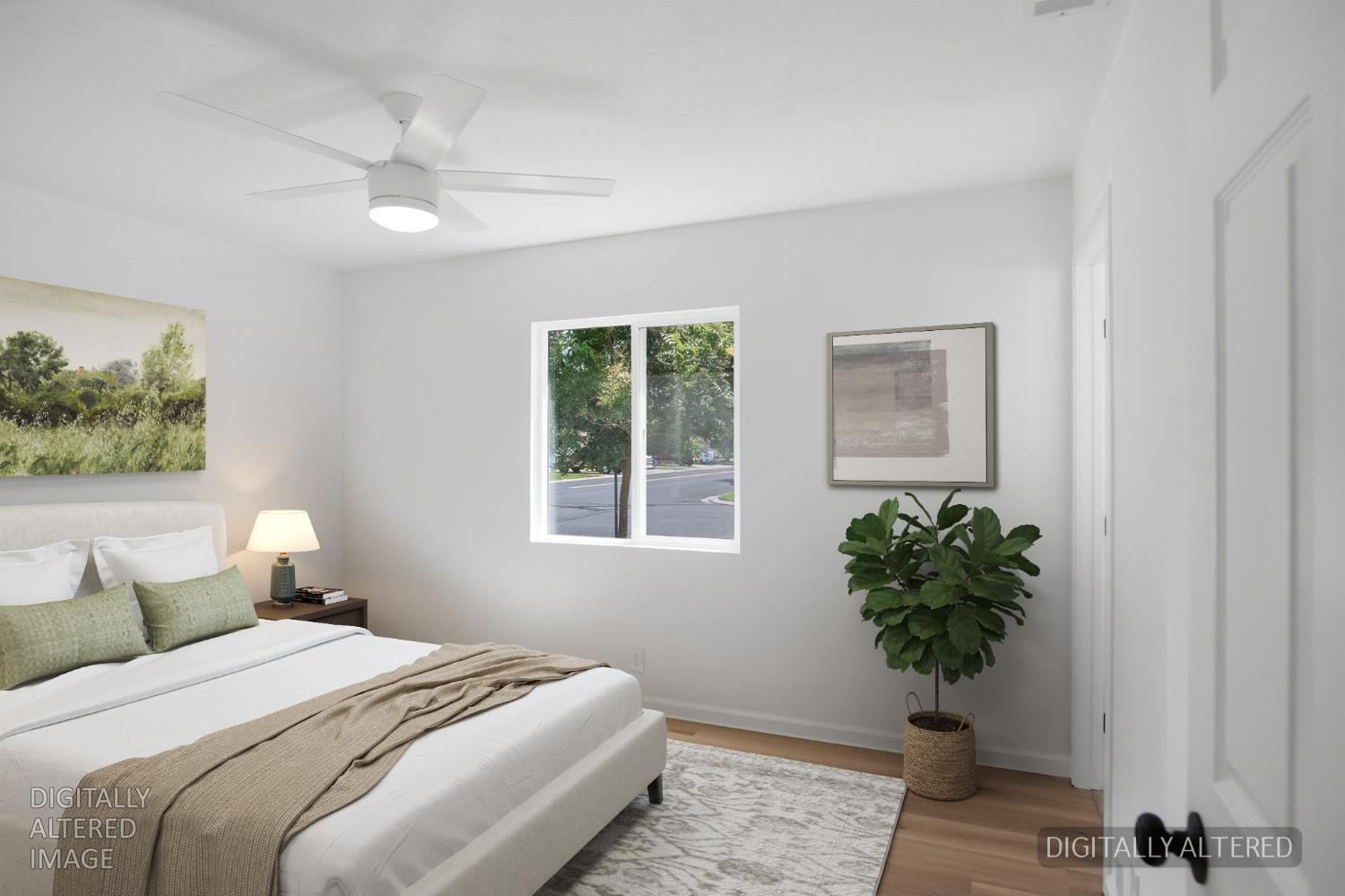 1451 Kent Way Modesto, CA 95355 - Photo 22 of 37 a bedroom with a bed and a potted plant