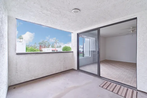 an empty room with large windows