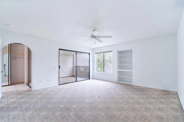 a view of an empty room with a ceiling fan