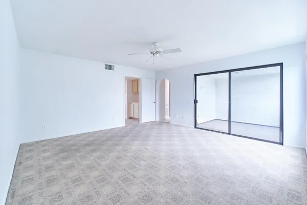 an empty room with windows and closet