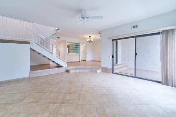 a view of an empty room with a fireplace and a window