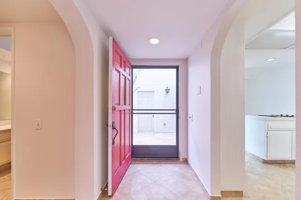 a kitchen that has a lot of white cabinets and white appliances