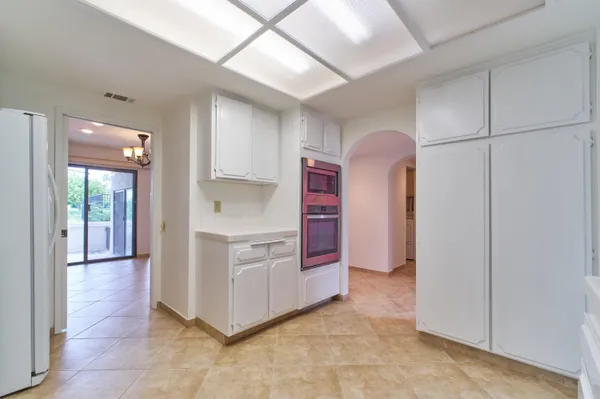 a kitchen with granite countertop a sink stove and refrigerator