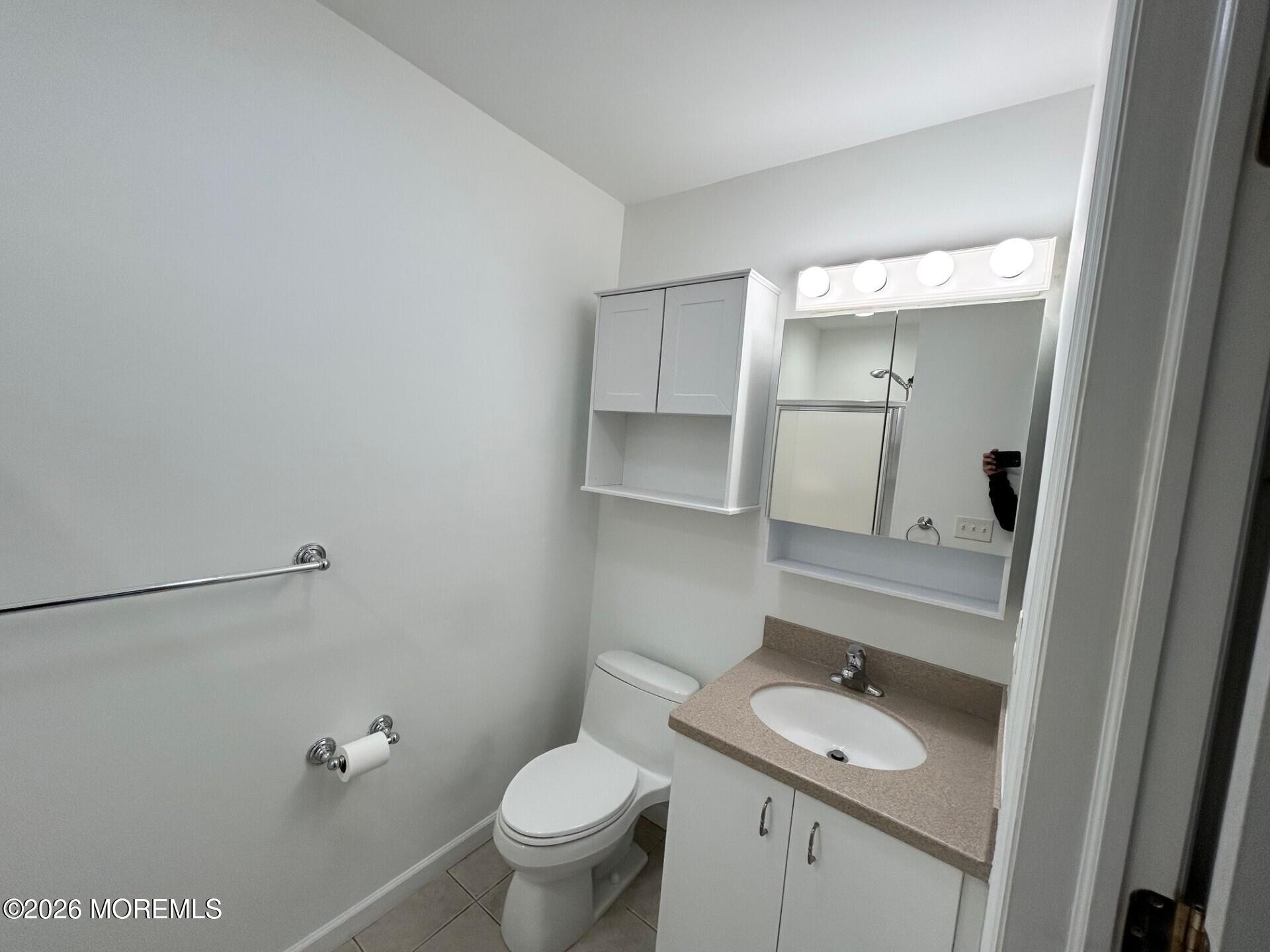 101 Main Street Farmingdale, NJ 07727 - Photo 6 of 12 a bathroom with a sink toilet and vanity