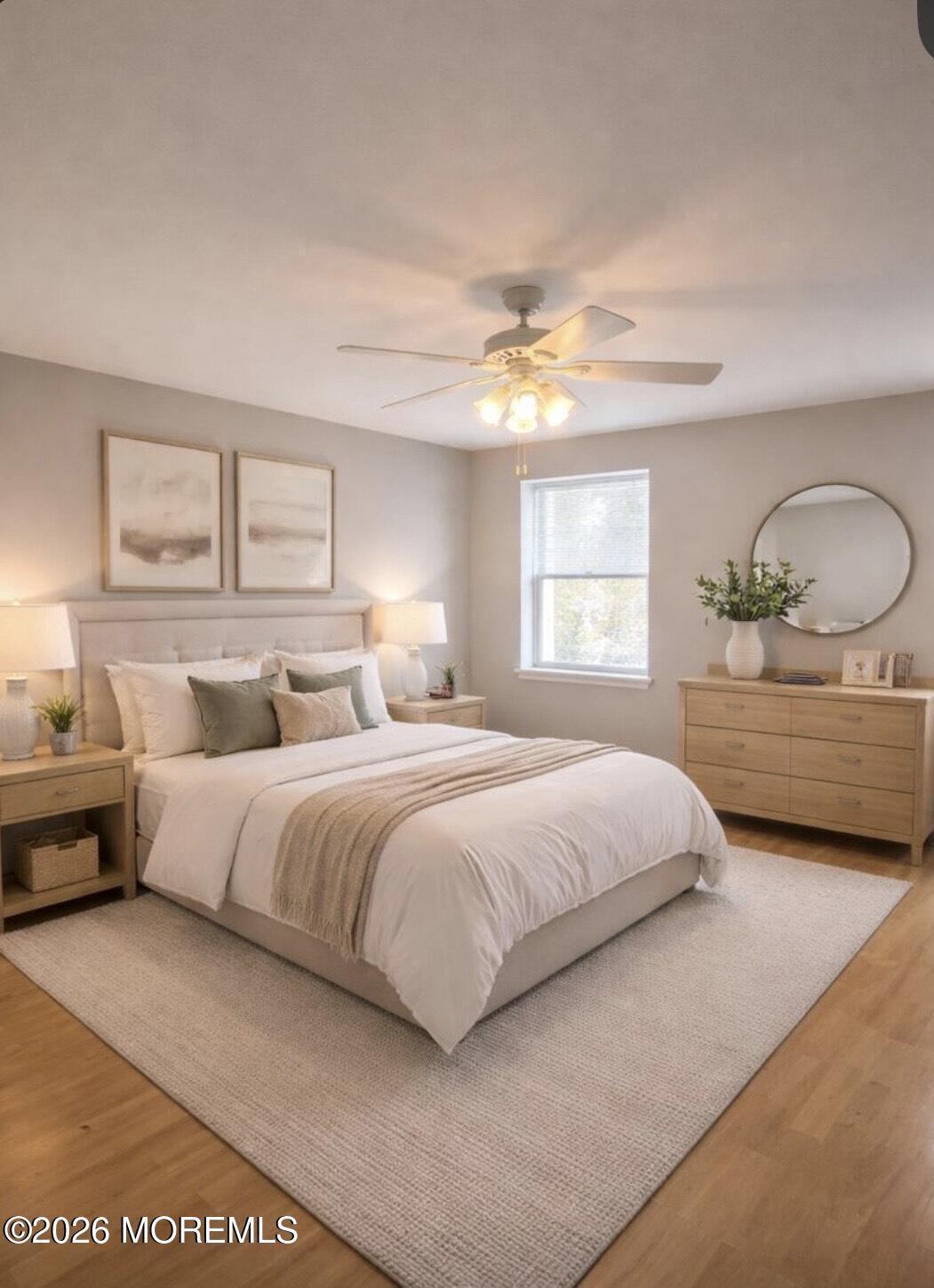 101 Main Street Farmingdale, NJ 07727 - Photo 8 of 12 a spacious bedroom with a large bed and a chandelier