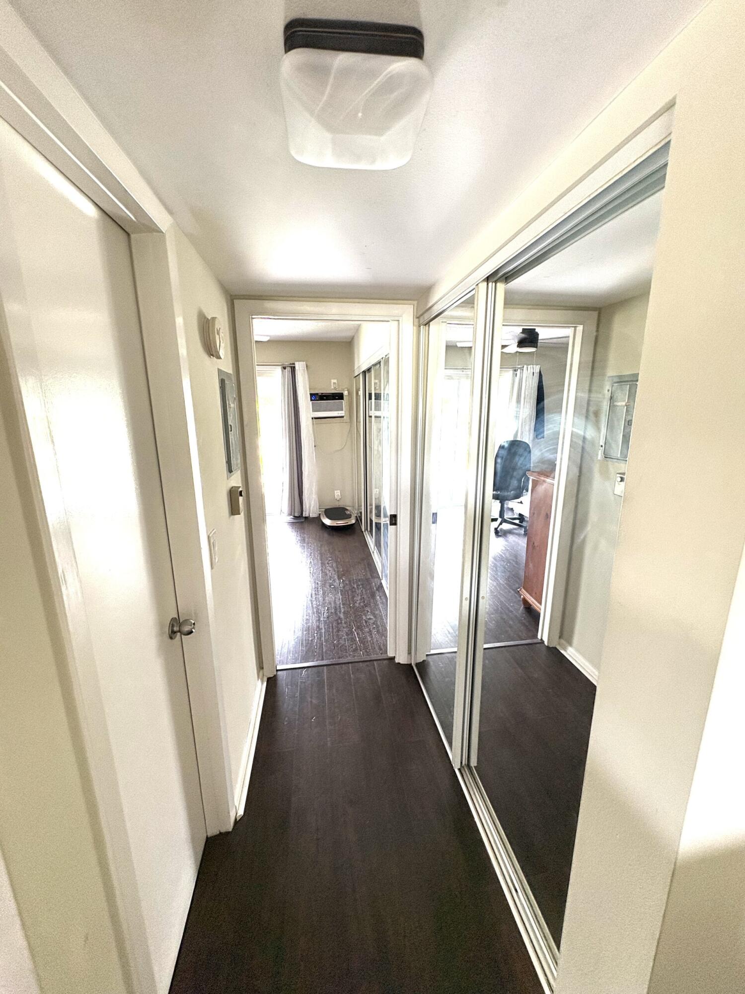 65 Preston F Boca Raton, FL 33434 - Photo 11 of 22 a view of a hallway with wooden floor and stairs