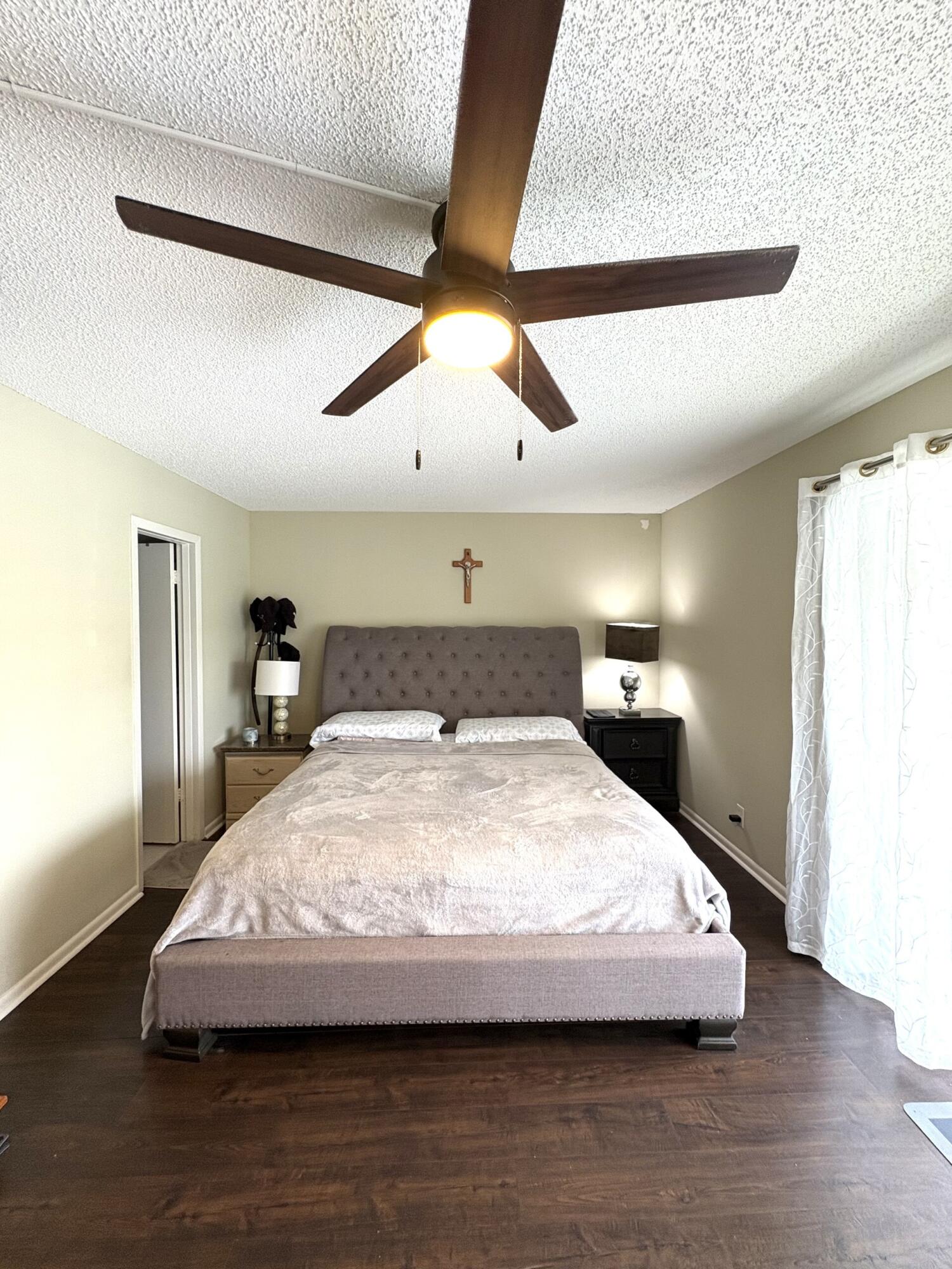 65 Preston F Boca Raton, FL 33434 - Photo 12 of 22 a bedroom with a bed and a night stand