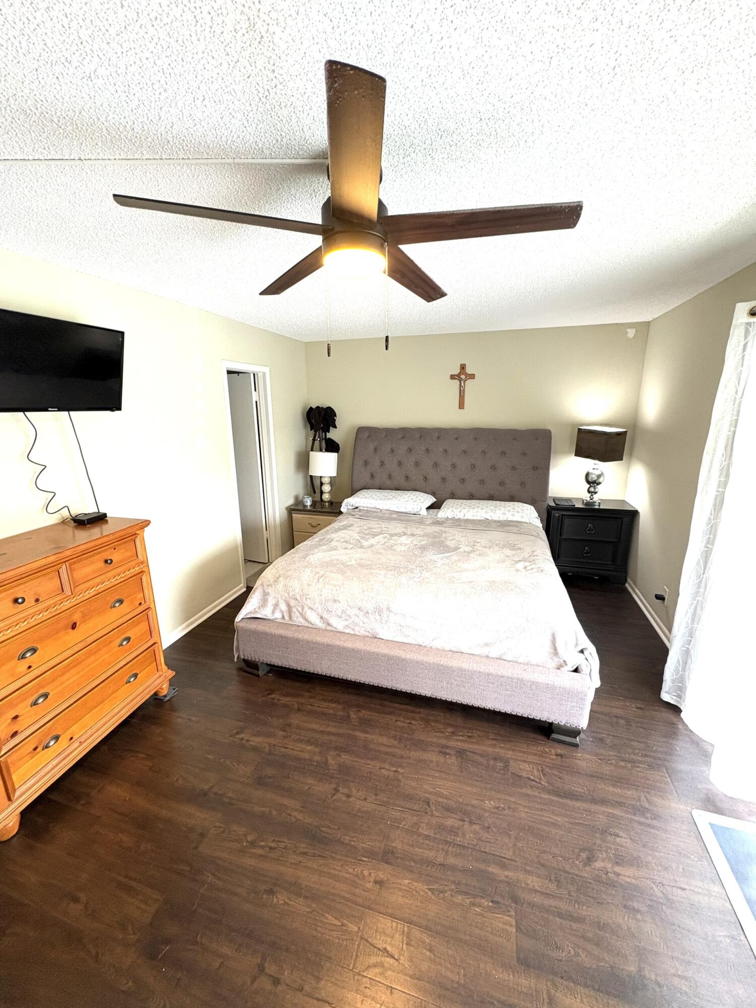 65 Preston F Boca Raton, FL 33434 - Photo 13 of 22 a large bedroom with a bed and wooden floor