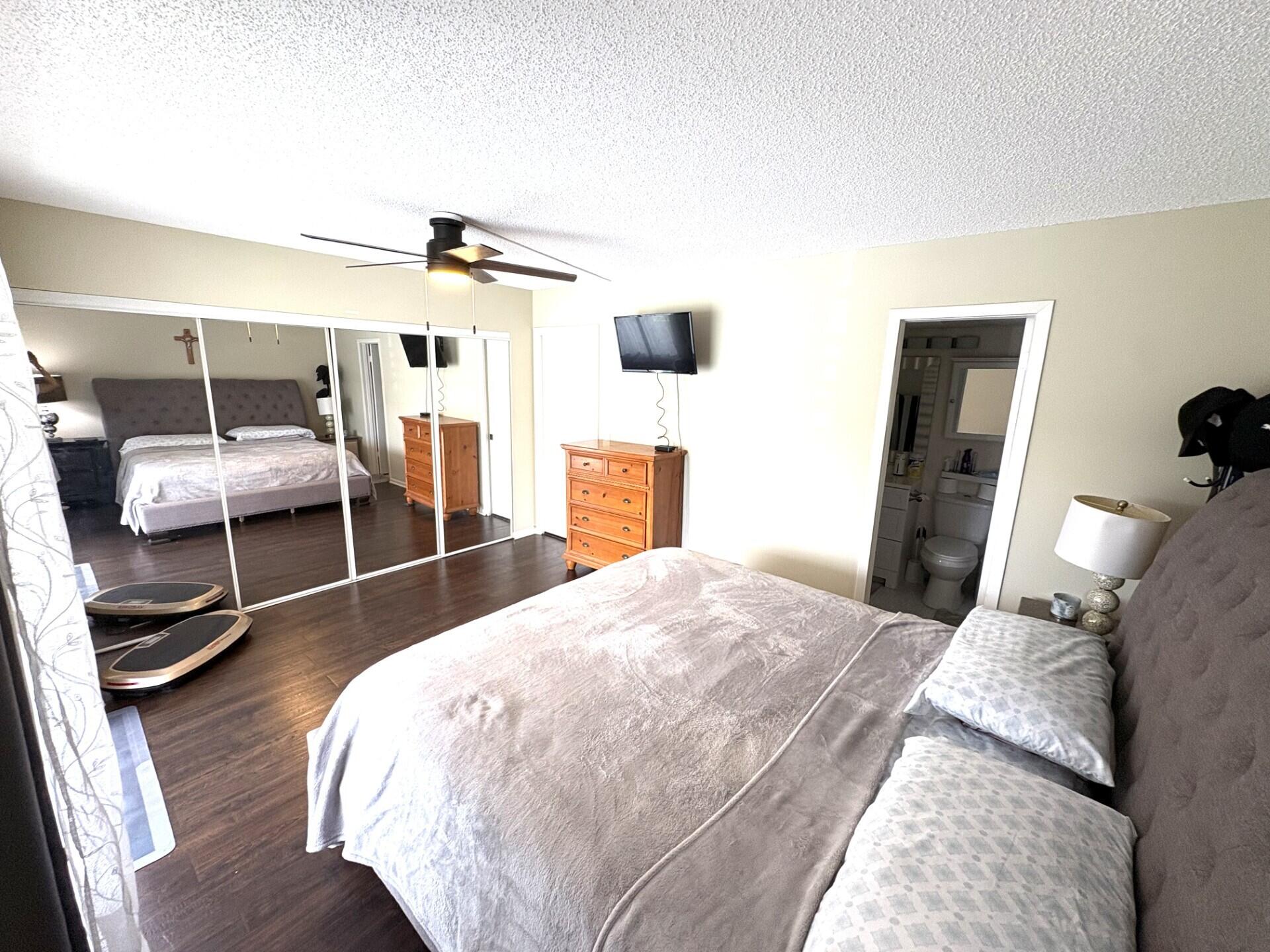 65 Preston F Boca Raton, FL 33434 - Photo 15 of 22 a bedroom with a bed and wooden floor