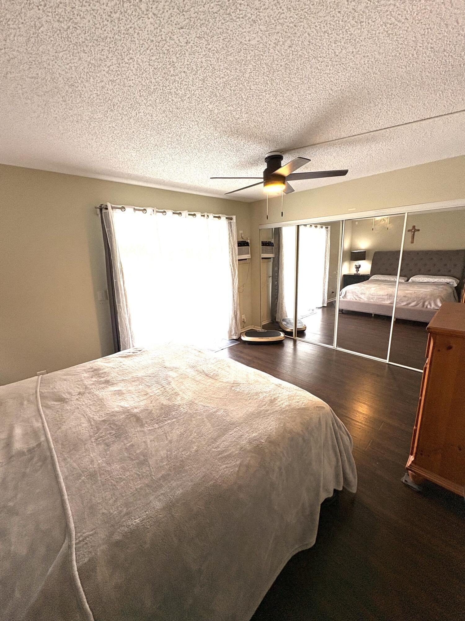 65 Preston F Boca Raton, FL 33434 - Photo 16 of 22 a bedroom with a bed and wooden floor