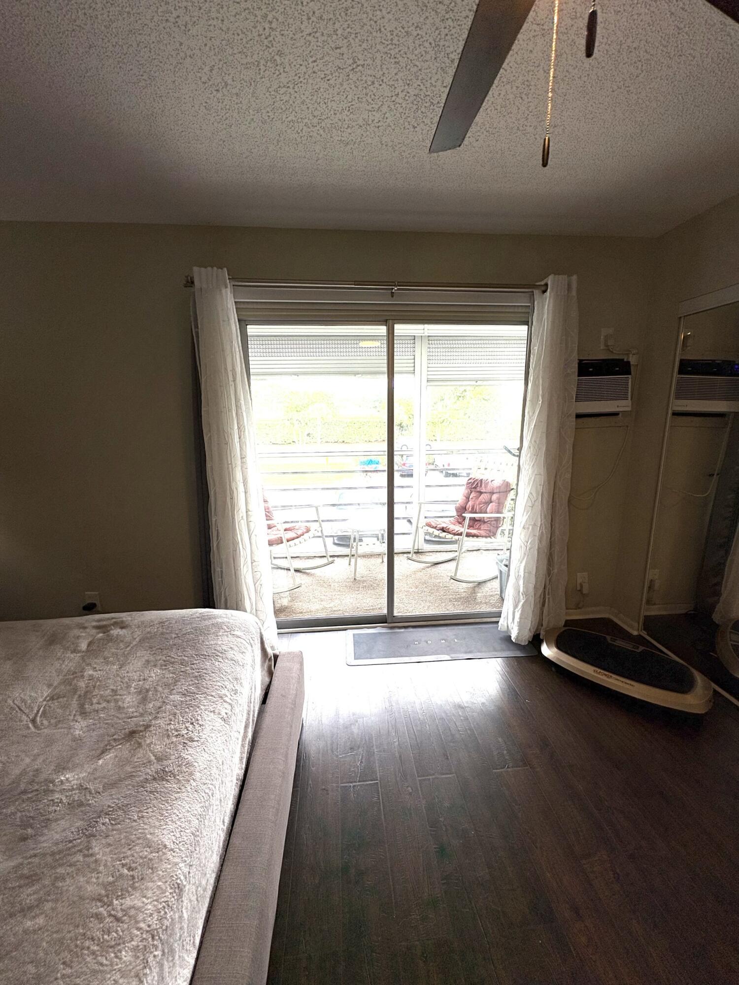 65 Preston F Boca Raton, FL 33434 - Photo 20 of 22 a view of a room with wooden floor and windows
