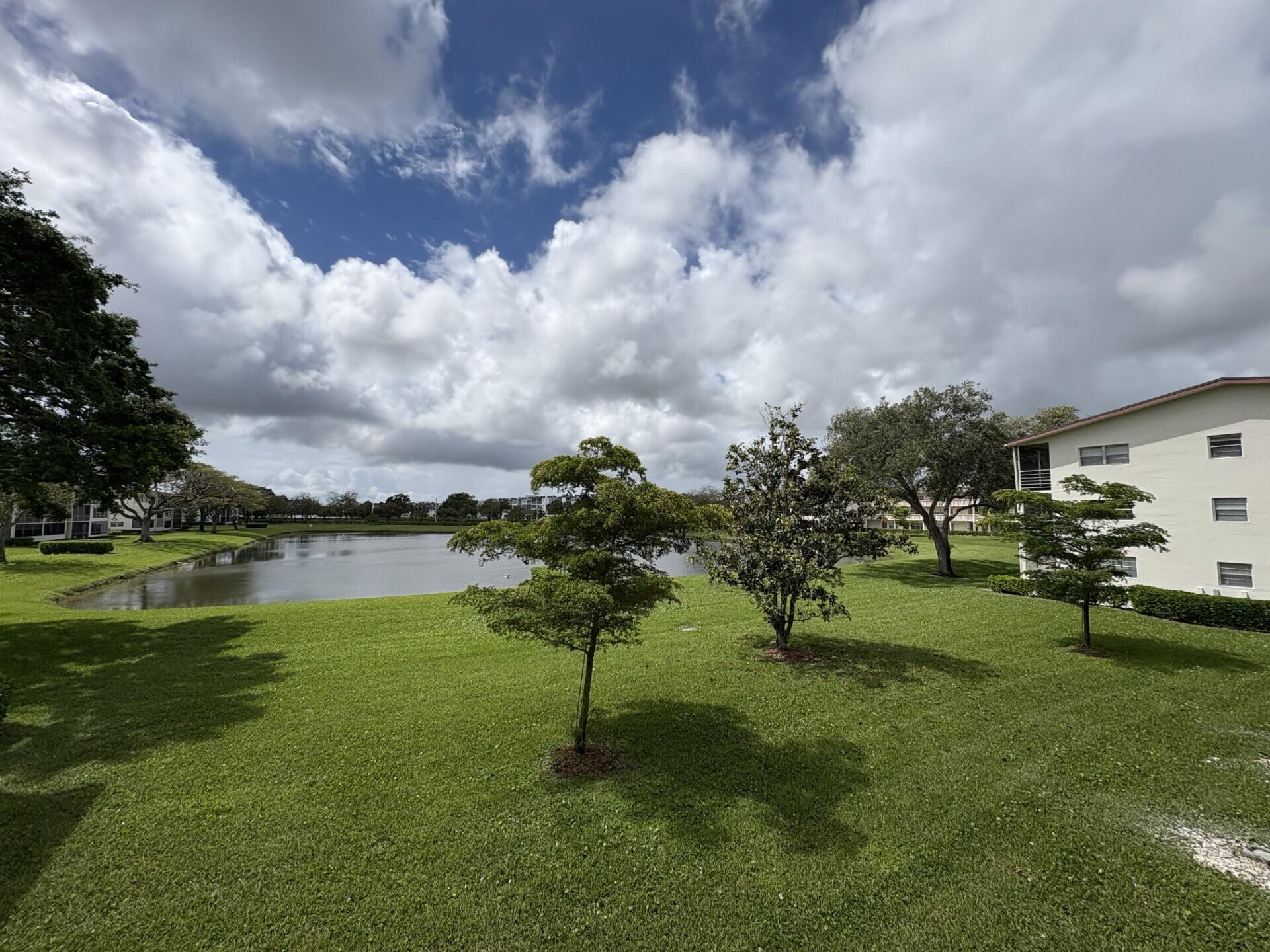65 Preston F Boca Raton, FL 33434 - Photo 22 of 22 a view of a lake with a yard