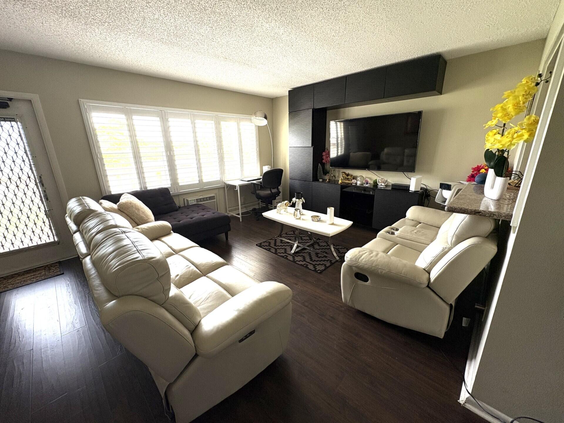 65 Preston F Boca Raton, FL 33434 - Photo 6 of 22 a living room with furniture and a flat screen tv