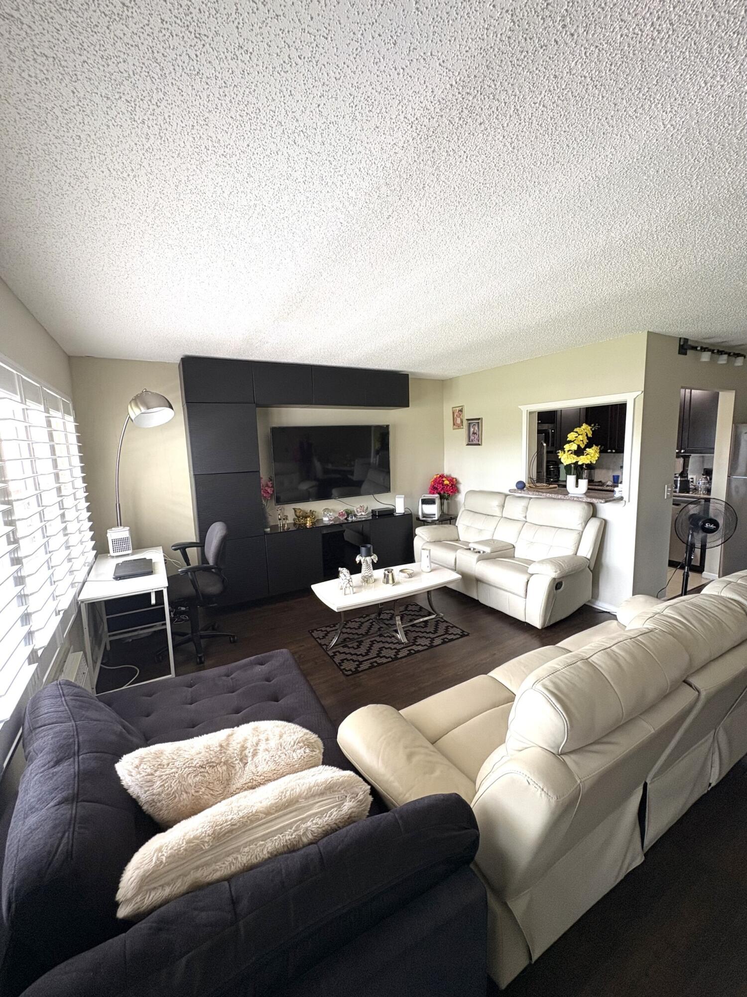 65 Preston F Boca Raton, FL 33434 - Photo 7 of 22 a living room with furniture and a fireplace