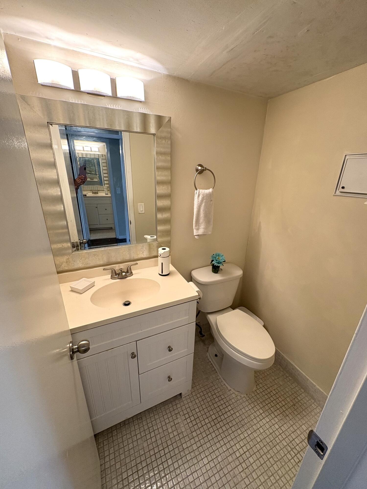 65 Preston F Boca Raton, FL 33434 - Photo 10 of 22 a bathroom with a toilet sink and mirror