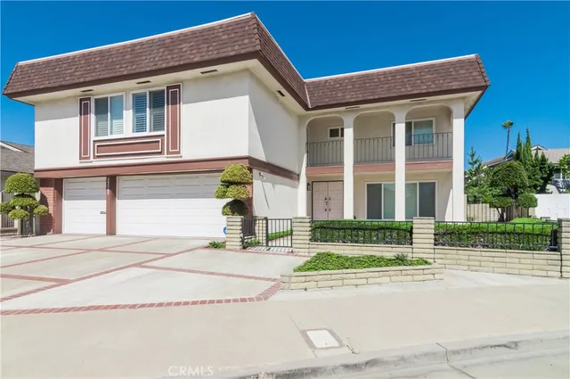 a front view of a house with a garden and plants