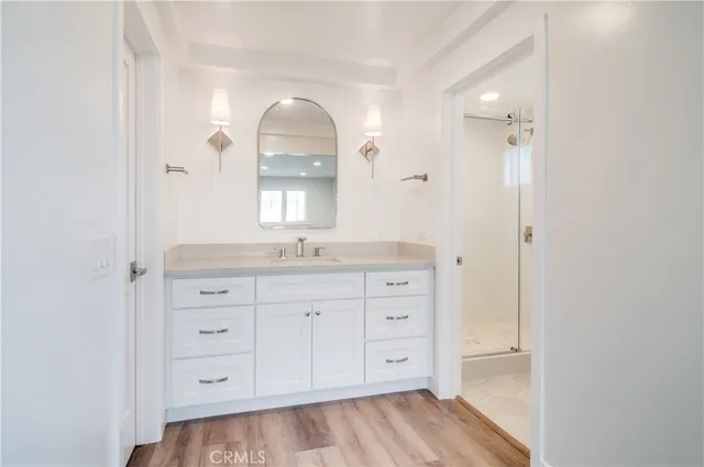 a spacious bathroom with a granite countertop sink mirror and