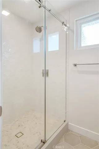 a bathroom with a glass shower door
