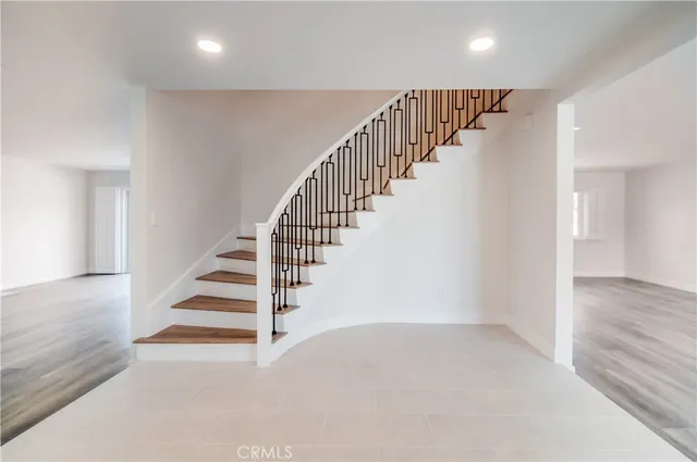 a view of entryway and hall with wooden floor