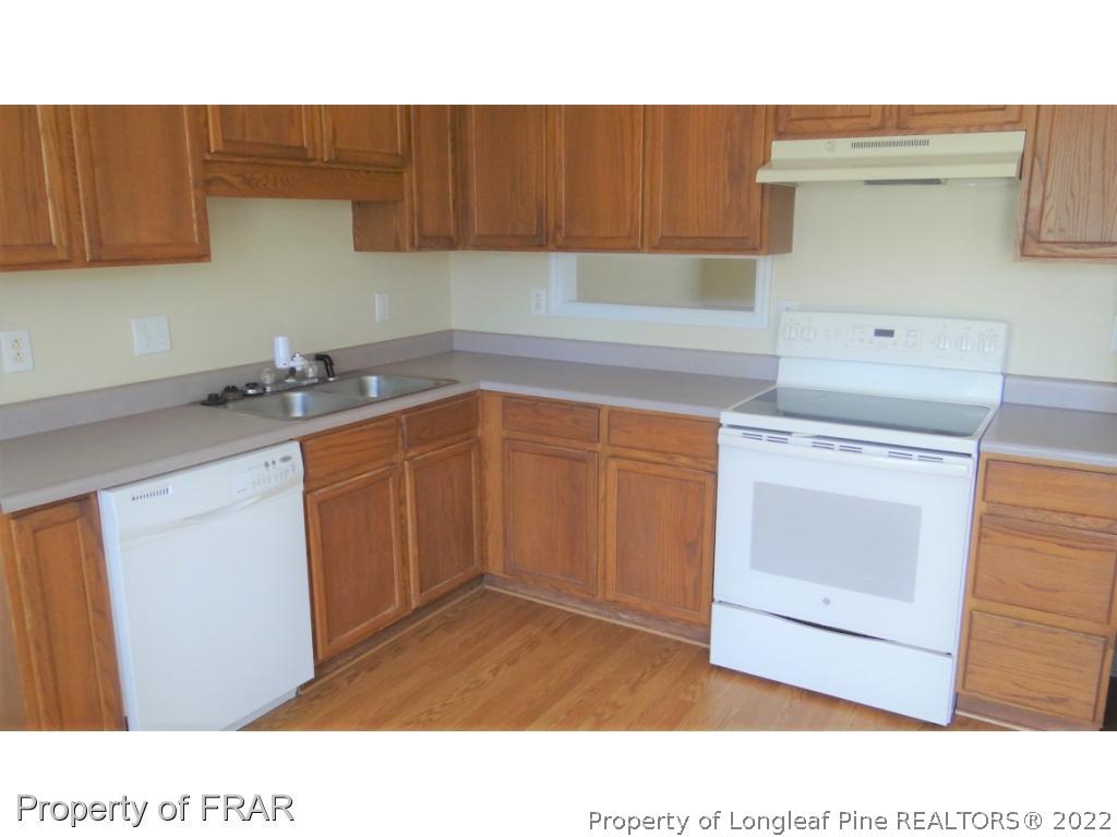 209 Pecan Trace Road Raeford, NC 28376 - Photo 12 of 31 a kitchen with a sink and cabinets