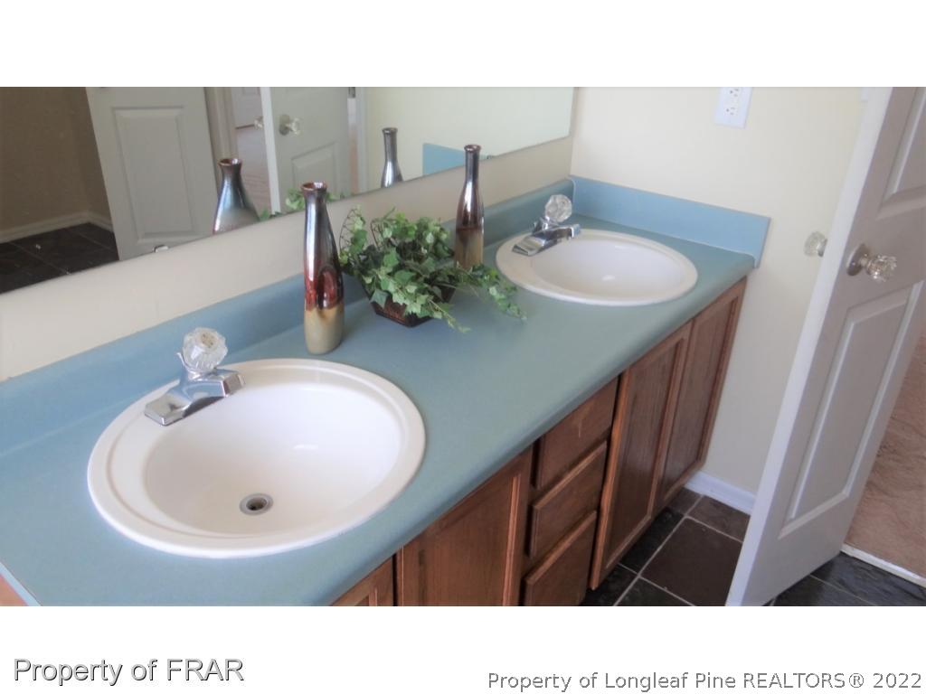 209 Pecan Trace Road Raeford, NC 28376 - Photo 22 of 31 a bathroom with a sink a mirror and vanity