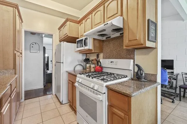 a kitchen with stainless steel appliances granite countertop a stove and a refrigerator