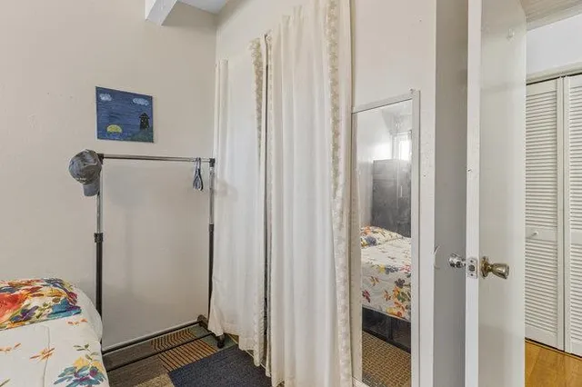 a bedroom with a bed and a window