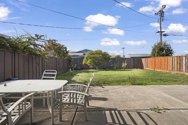 a view of a patio with table and chairs and potted plants